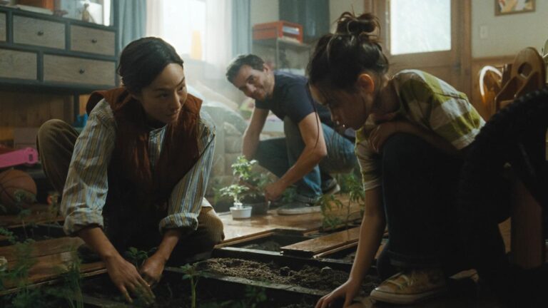 Family growing vegetables inside their home in The Last House.