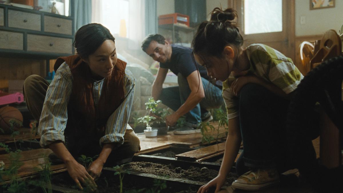 Family growing vegetables inside their home in The Last House.